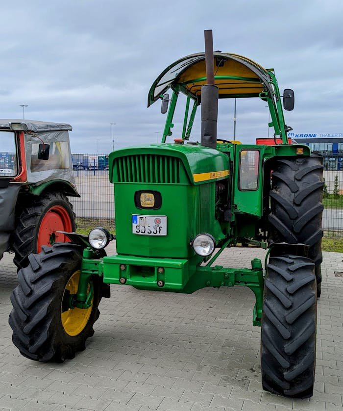 A vintage green tractor parked outdoors in Werlte, Germany, showcasing classic agricultural machinery.